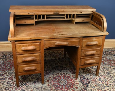Lot 2772 - An early 20th century oak roll top desk, the...