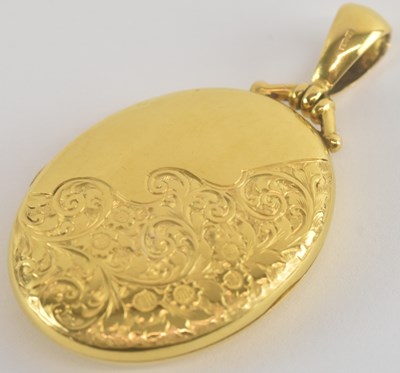 Lot 1271 - A 15ct gold oval locket, the front with half...