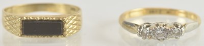 Lot 1239 - Two gold rings comprising an 18ct three stone...