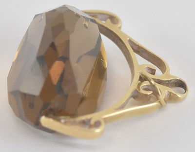 Lot 1204 - A three sided cut smoky quartz swivel fob, in...