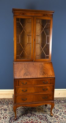 Lot 3051 - A reproduction mahogany bureau bookcase, the...