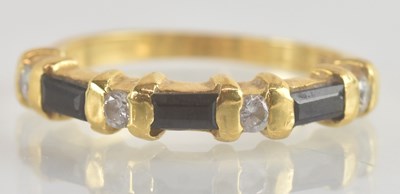 Lot 1237 - An 18ct diamond and sapphire set ring, with...