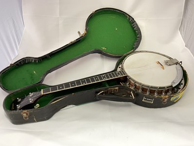 Lot 185 - VEGA; a cased four string banjo with mother of...