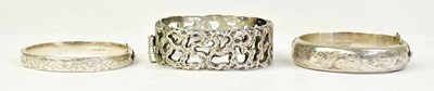 Lot 1424 - Three hallmarked silver hinged bangles,...