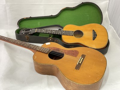 Lot 184 - A cased four string ukulele with mother of...