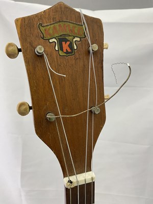 Lot 184 - A cased four string ukulele with mother of...