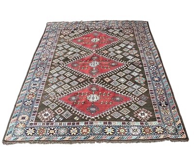 Lot 1297 - A brown ground Turkmen wool carpet, with...