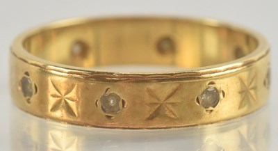 Lot 1227 - An 18ct gold band ring, with inset tiny white...