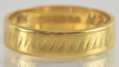 Lot 1217 - A 22ct gold band ring, size O, approx 4.3g.