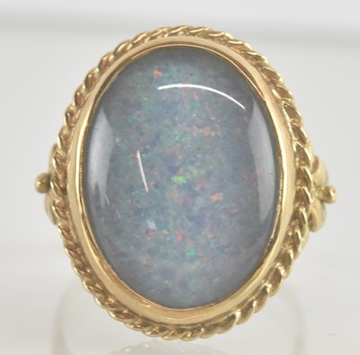 Lot 1240 - A 9ct yellow gold opal set dress ring, the...