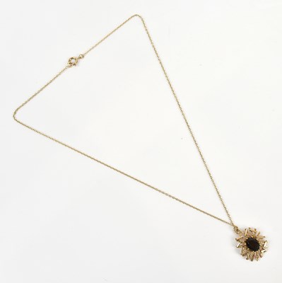 Lot 298 - A 9ct textured gold pendant set with an oval...