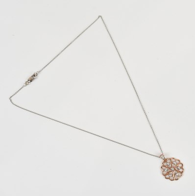 Lot 288 - A rose coloured metal diamond set pendant,...