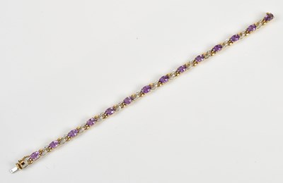Lot 46 - A yellow metal diamond and amethyst set tennis...