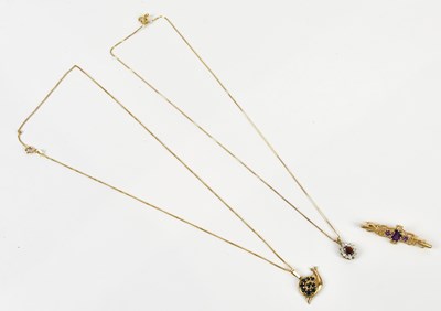Lot 285 - A 9ct yellow gold cluster pendant set with an...