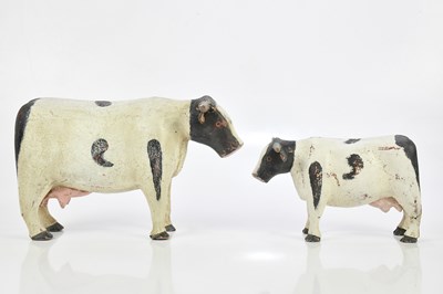 Lot 1467 - Two naive carved cows, larger 21cm (2).