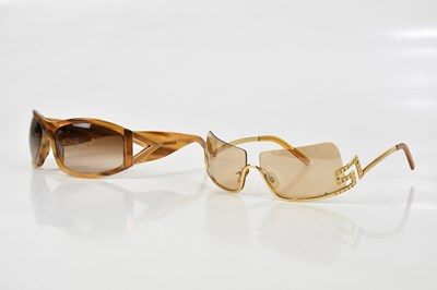 Lot 690 - VERSACE; a pair of gold tone half rimmed...