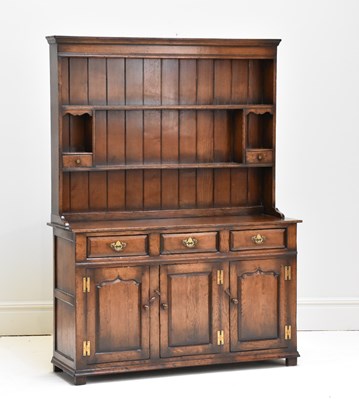 Lot 1095 - A reproduction oak dresser, with three drawers...