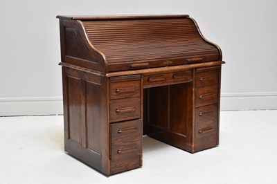 Lot 1180 - A 1920s oak roll top desk, with an arrangement...