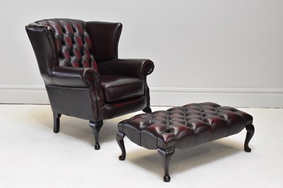 Lot 1096 - A large reproduction wing-back elbow chair,...
