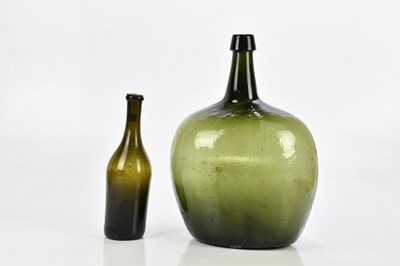 Lot 2391 - A large green glass onion bottle, height 43cm,...