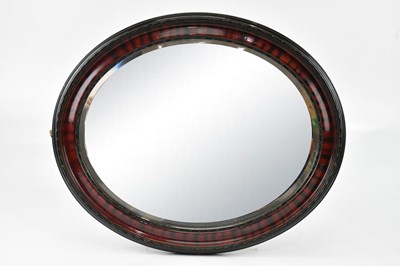 Lot 1053 - An oval framed and bevelled edge mirror, 60 x...