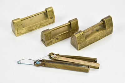 Lot 1551 - A group of three Chinese brass locks, with...