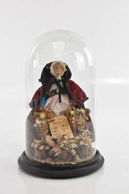 Lot 2060 - A pedlar doll flower seller, under glass dome,...
