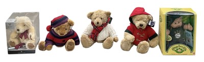 Lot 555 - A collection of boxed dolls and teddy bears,...