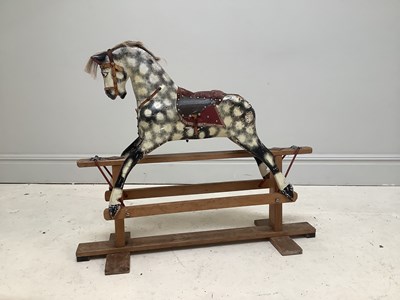 Lot 2121 - A carved pine and gesso rocking horse, on pine...