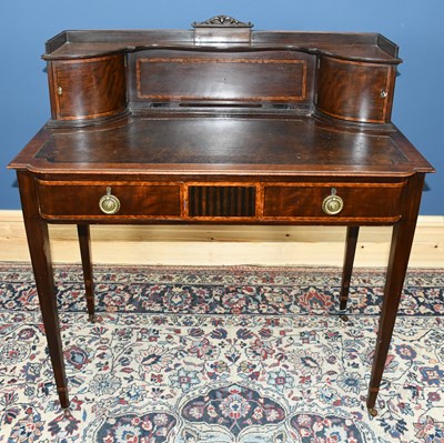 Lot 2761 - An Edwardian mahogany writing table, the upper...