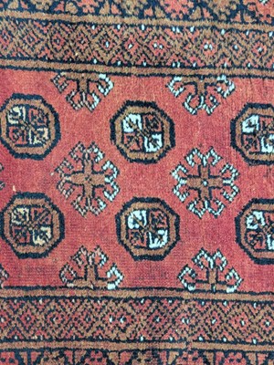 Lot 1301 - A Bokhara red ground wool runner, worked with...
