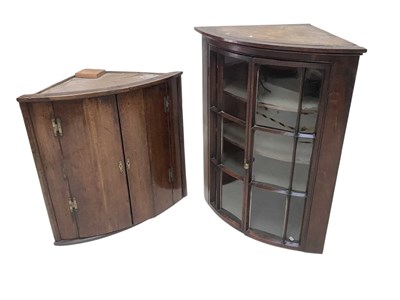 Lot 1081 - A George III oak hanging corner cupboard, with...