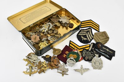 Lot 1556 - A collection of army patches, cap badges and...