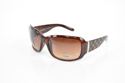 Lot 732 - VERSACE; a pair of unused brown sunglasses...