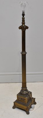 Lot 1823 - A brass Ionic column standard lamp, height 144cm.