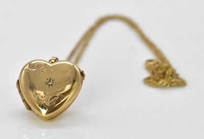 Lot 543 - A 9ct yellow gold heart shaped locket...