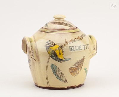 Lot 735 - A slipware jar and cover decorated with a blue...