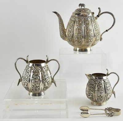 Lot 1089 - An Indian white metal three-piece tea service,...