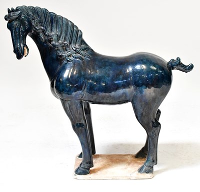 Lot 372 - A Tang-style ceramic model of a standing horse...