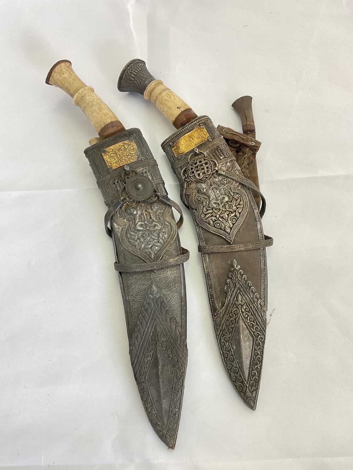 Lot 128 - A pair of ornately decorated kukri knives with...