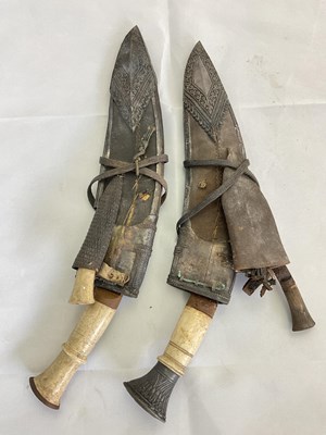 Lot 128 - A pair of ornately decorated kukri knives with...