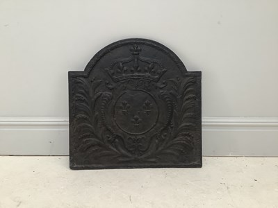 Lot 1287 - A cast iron fleur-de-lys fireback, 65 x 66cm.