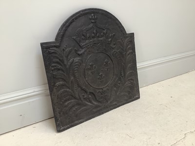 Lot 1287 - A cast iron fleur-de-lys fireback, 65 x 66cm.