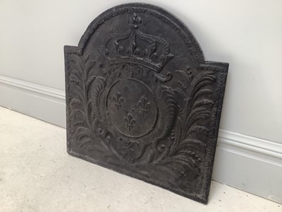 Lot 1287 - A cast iron fleur-de-lys fireback, 65 x 66cm.