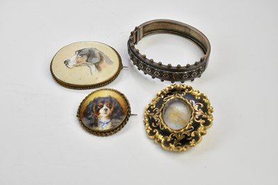 Lot 1545 - Two ceramic hand painted brooches, each with...