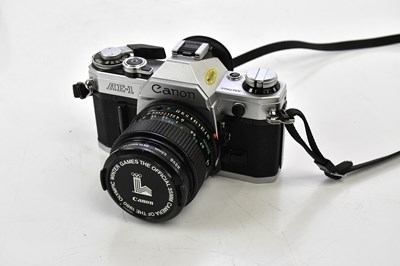 Lot 1695 - A cased Canon AE1, together with lenses and...
