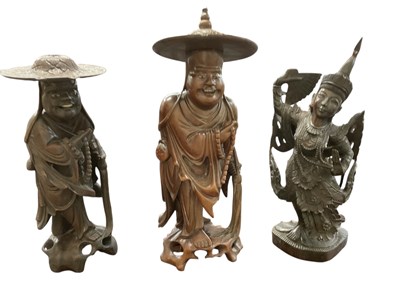Lot 1025 - Three Chinese carved rootwood figures,...