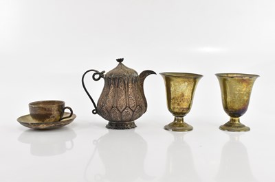 Lot 2362 - An Indian white metal teacup and saucer, an...