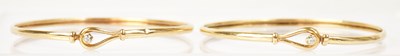 Lot 1415 - A pair of 9ct yellow gold bangles, each set...