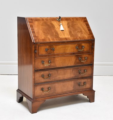 Lot 1122 - A George III style walnut bureau, with four...